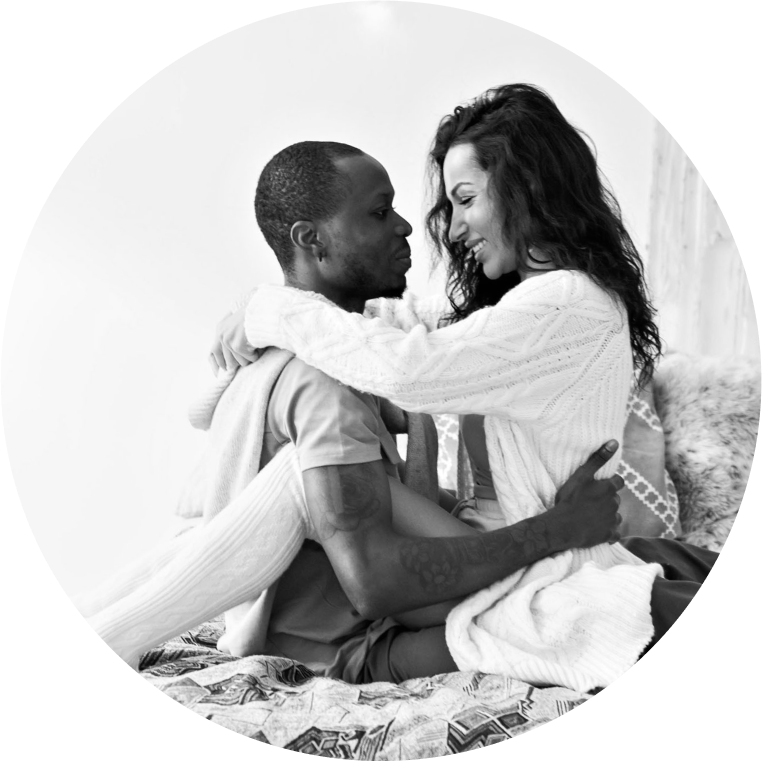 Woman sitting on top of her partner in bed