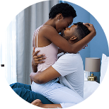 couple kissing intimately in bedroom while playing couples game