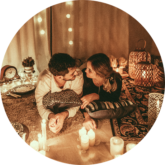 romantic couple setting at home with candles for valentine's day