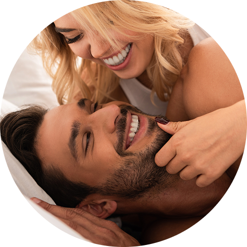 happy couple laughing and having fun in bedroom