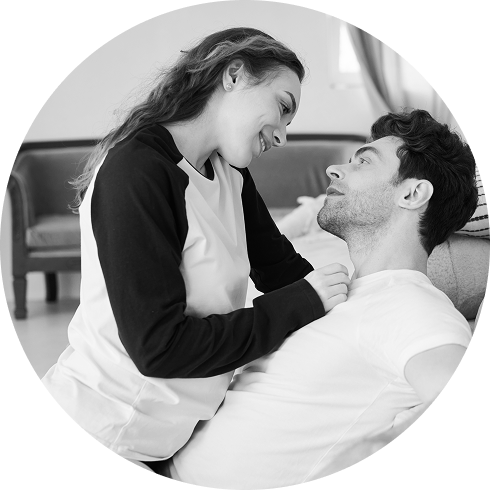 man sitting on couch beside woman asking sexy question