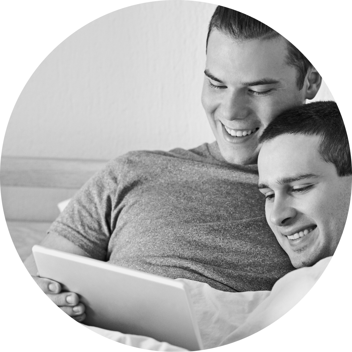 Male couple playing game for couples on table in bed